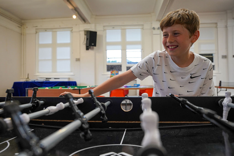 a picture of a boy playing table football 